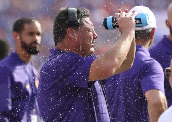 GAINESVILLE, FL - OCTOBER 07: LSU Tigers head coach Ed Orgeron cools off by spraying water in his face during the college football game between the LSU Tigers and Florida Gators on October 07, 2017, at Ben Hill Griffin Stadium at Florida Field in Gainesville, FL.