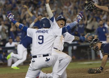 October 16, 2018 - Los Angeles, California, U.S - Manny Machado #8 of the Los Angeles Dodgers scores the winning run in the 13th inning and celebrates with Yasmani Grandal #9 during their National League Championship Series Game 4 with the Milwaukee Brewers. Dodgers defeat Brewers, 2-1 (Photo by Prensa Internacional/Zuma Press/Icon Sportswire)