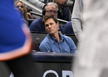 Nov 27, 2024; Dallas, Texas, USA; Former NFL quarterback Tom Brady watches the game between the Dallas Mavericks and the New York Knicks during the second quarter at the American Airlines Center. Mandatory Credit: Jerome Miron-Imagn Images