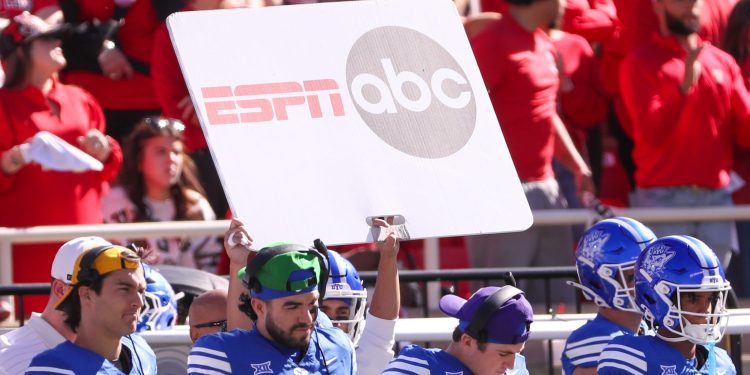 A sign depicting logos of ESPN and ABC is seen on the BYU sideline during a Big 12 Conference football game, Saturday, Nov. 8, 2025, at Jones AT&T Stadium. (© Nathan Giese/Avalanche-Journal / USA TODAY NETWORK via Imagn Images)