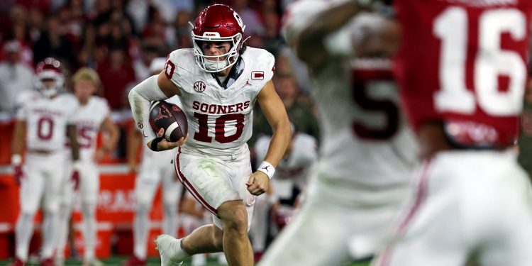 Nov 15, 2025; Tuscaloosa, Alabama, USA;  Oklahoma Sooners quarterback John Mateer (10) runs the ball during the third quarter against the Alabama Crimson Tide at Saban Field at Bryant-Denny Stadium. Mandatory Credit: David Leong-Imagn Images