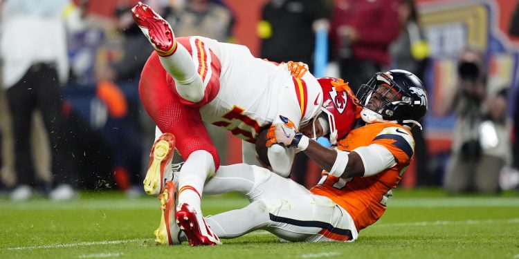 Nov 16, 2025; Denver, Colorado, USA; Denver Broncos cornerback Ja'Quan McMillian (29) sacks Kansas City Chiefs quarterback Patrick Mahomes (15) in the fourth quarter at Empower Field at Mile High. Mandatory Credit: Ron Chenoy-Imagn Images