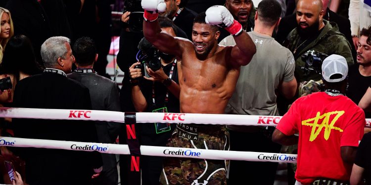 3DC646K Anthony Joshua celebrates victory after knocking down Jake Paul at the Kaseya Center, Miami, Florida. Friday December 19, 2026.
