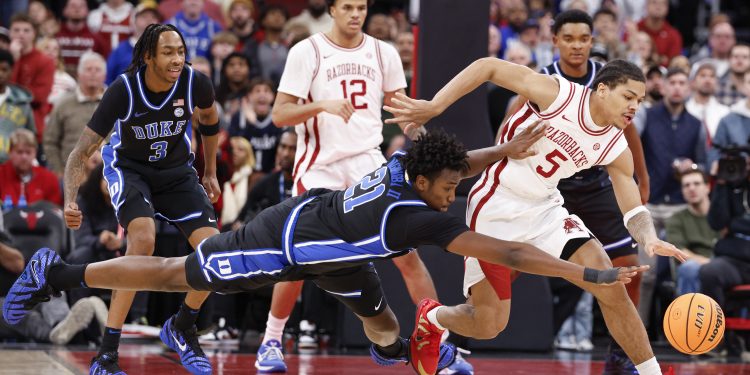 Nov 27, 2025; Chicago, Illinois, USA; Arkansas Razorbacks guard Darius Acuff Jr. (5) battles for the ball with Duke Blue Devils center Patrick Ngongba (21) during the second half at United Center. Mandatory Credit: Kamil Krzaczynski-Imagn Images