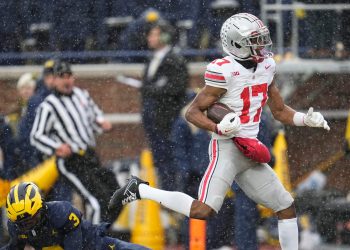 Ohio State Buckeyes wide receiver Carnell Tate (17) scores a touchdown over Michigan Wolverines defensive back Jaden Mangham (3) during the NCAA football game at Michigan Stadium in Ann Arbor, Mich. on Nov. 29, 2025. Ohio State won 27-9.