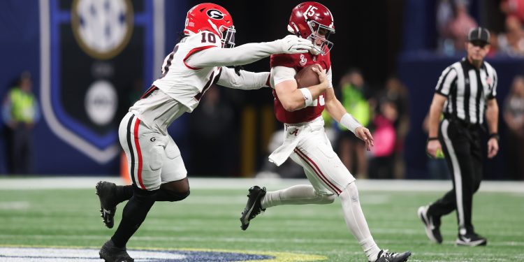 Dec 6, 2025; Atlanta, GA, USA; Alabama Crimson Tide quarterback Ty Simpson (15) scrambles and is tackled by Georgia Bulldogs linebacker Zayden Walker (10) during the fourth quarter during the 2025 SEC Championship game at Mercedes-Benz Stadium. Mandatory Credit: Brett Davis-Imagn Images