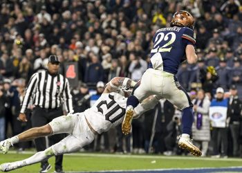 Dec 13, 2025; Baltimore, Maryland, USA;  Navy Midshipmen running back Eli Heidenreich (22) catches a touchdown in front of Army West Point Black Knights safety Casey Larkin (20) during the second half  at M&T Bank Stadium. Mandatory Credit: Tommy Gilligan-Imagn Images