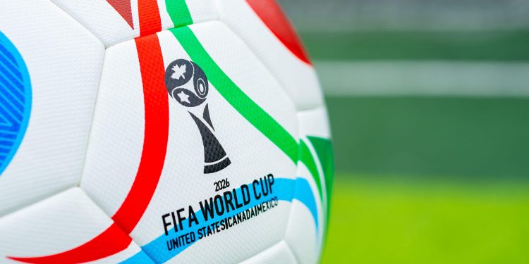 3CGTJ6C ZHONGSHAN China-August 3 2025: 2026 World Cup soccer in front of a soccer field at horizontal composition.