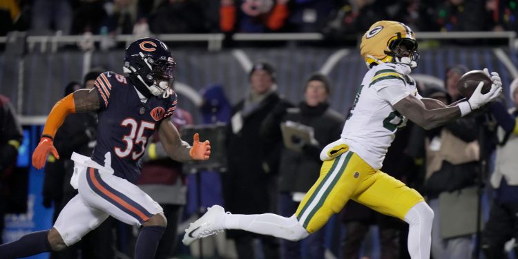 Green Bay Packers wide receiver Romeo Doubs (87) catches a touchdown pass while being covered by Chicago Bears safety C.J. Gardner-Johnson (35) during the third quarter of their game Saturday, December 20, 2025 at Soldier Field in Chicago, Illinois. The Chicago Bears beat the Green Bay Packers 22-16 in overtime.