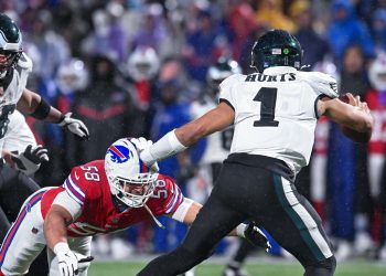 Dec 28, 2025; Orchard Park, New York, USA; Philadelphia Eagles quarterback Jalen Hurts (1) is pressured by Buffalo Bills linebacker Matt Milano (58) in the fourth quarter at Highmark Stadium. Mandatory Credit: Mark Konezny-Imagn Images