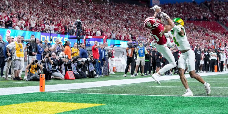 Indiana Hoosiers wide receiver Charlie Becker (80) makes a catch in front of Oregon Ducks defensive back Brandon Finney (4) for a touchdown Friday, Jan. 9, 2026, during the Peach Bowl and semifinal game of the College Football Playoff at Mercedes-Benz Stadium in Atlanta.