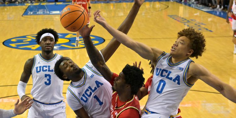 Jan 10, 2026; Los Angeles, California, USA;  UCLA Bruins center Xavier Booker (1), guard Trent Perry (0) and Maryland Terrapins forward Solomon Washington (9) battle for a rebound in the first half at Pauley Pavilion presented by Wescom Financial. Mandatory Credit: Jayne Kamin-Oncea-Imagn Images