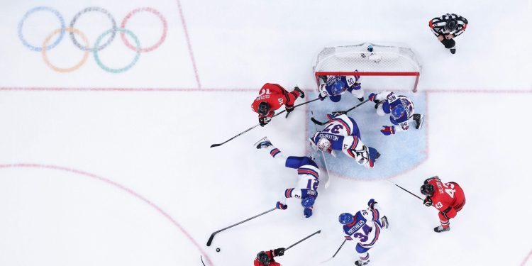 3DTJNE5 Milan, Italy. 22nd Feb, 2026. Goalkeeper Connor Hellebuyck of the United States saves the puck during the ice hockey men's gold medal game between Canada and the United States at the Milan-Cortina 2026 Olympic Winter Games in Milan, Italy, Feb. 22, 2026. Credit: Tao Xiyi/Xinhua/Alamy Live News