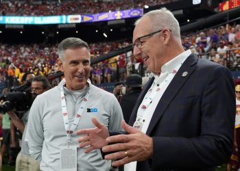 Sep 1, 2024; Paradise, Nevada, USA; Big 10 commissioner 
Tony Petitti (left) and SEC commissioner Greg Sankey attend the game between the LSU Tigers and the Southern California Trojans at Allegiant Stadium. Mandatory Credit: Kirby Lee-USA TODAY Sports