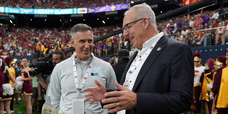 Sep 1, 2024; Paradise, Nevada, USA; Big 10 commissioner 
Tony Petitti (left) and SEC commissioner Greg Sankey attend the game between the LSU Tigers and the Southern California Trojans at Allegiant Stadium. Mandatory Credit: Kirby Lee-USA TODAY Sports