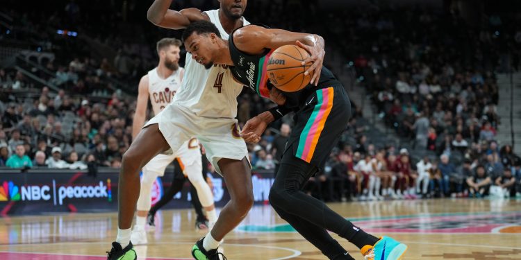 Dec 29, 2025; San Antonio, Texas, USA; San Antonio Spurs forward Victor Wembanyama (1) drives in against Cleveland Cavaliers center Evan Mobley (4) in the second half at Frost Bank Center. Mandatory Credit: Daniel Dunn-Imagn Images