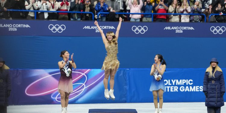 Feb 19, 2026; Milan, Italy; Gold medalist Alysa Liu of the United States and silver medalist Kaori Sakamoto of Japan and bronze medalist Ami Nakai of Japan celebrate during the medal ceremony in the women's free skate during the Milano Cortina 2026 Olympic Winter Games at Milano Ice Skating Arena. Mandatory Credit: James Lang-Imagn Images