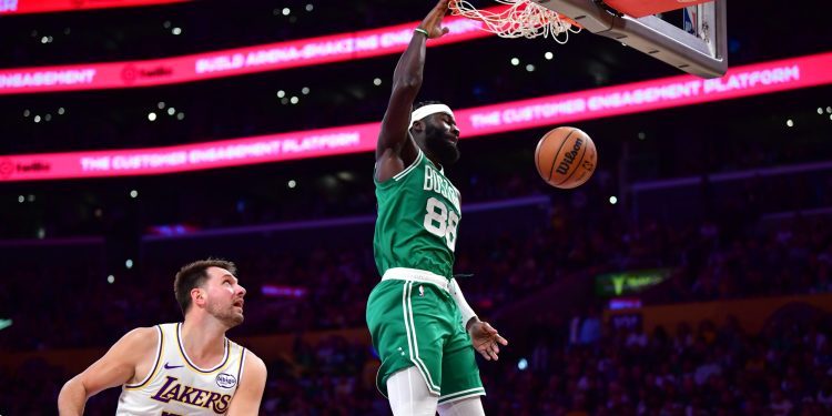 Feb 22, 2026; Los Angeles, California, USA; Boston Celtics center Neemias Queta (88) dunks for the basket ahead of Los Angeles Lakers guard Luka Doncic (77) during the first half at Crypto.com Arena. Mandatory Credit: Gary A. Vasquez-Imagn Images