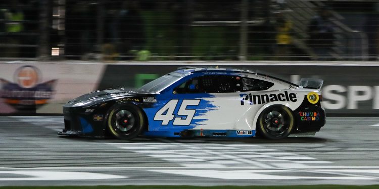 Feb 22, 2026; Hampton, Georgia, USA;  NASCAR Cup Series driver Tyler Reddick crosses the finish line at EchoPark Speedway. Mandatory Credit: Mady Mertens-Imagn Images