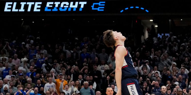 UConn guard Braylon Mullins (24) celebrates after a basket against Duke during the second half in the Elite Eight of the NCAA college basketball tournament, Sunday, March 29, 2026, in Washington. (AP Photo/Stephanie Scarbrough)