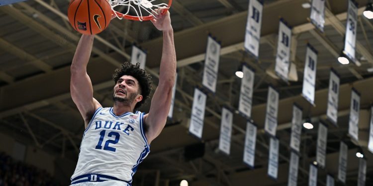 Mar 7, 2026; Durham, North Carolina, USA; Duke Blue Devils forward Cameron Boozer (12) dunks during the second half against the North Carolina Tar Heels at Cameron Indoor Stadium.  The Duke Blue Devils won 76-61. Mandatory Credit: Rob Kinnan-Imagn Images