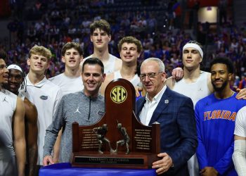 Mar 3, 2026; Gainesville, Florida, USA; The Florida Gators are honored for winning the SEC Regular Season Championship with SEC Commissioner Greg Sankey before the game against the Mississippi State Bulldogs at Exactech Arena at the Stephen C. O'Connell Center. Mandatory Credit: Morgan Tencza-Imagn Images