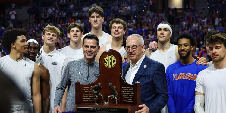 Mar 3, 2026; Gainesville, Florida, USA; The Florida Gators are honored for winning the SEC Regular Season Championship with SEC Commissioner Greg Sankey before the game against the Mississippi State Bulldogs at Exactech Arena at the Stephen C. O'Connell Center. Mandatory Credit: Morgan Tencza-Imagn Images