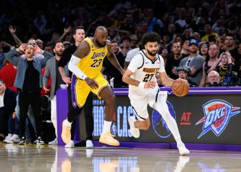 Mar 14, 2026; Los Angeles, California, USA; Denver Nuggets guard Jamal Murray (27) controls the ball while under pressure from Los Angeles Lakers forward LeBron James (23)during the second half at Crypto.com Arena. Mandatory Credit: William Liang-Imagn Images