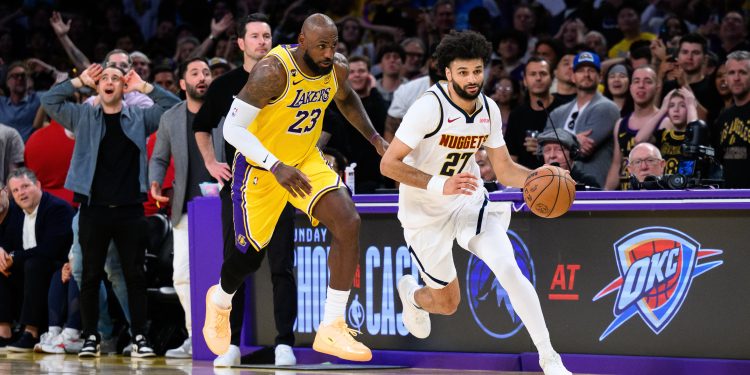 Mar 14, 2026; Los Angeles, California, USA; Denver Nuggets guard Jamal Murray (27) controls the ball while under pressure from Los Angeles Lakers forward LeBron James (23)during the second half at Crypto.com Arena. Mandatory Credit: William Liang-Imagn Images