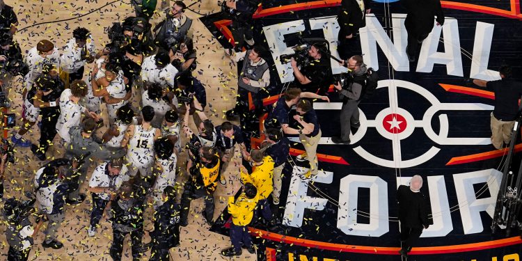 Michigan celebrates after defeating UConn in the NCAA college basketball tournament national championship game at the Final Four, Monday, April 6, 2026, in Indianapolis. (AP Photo/AJ Mast)
