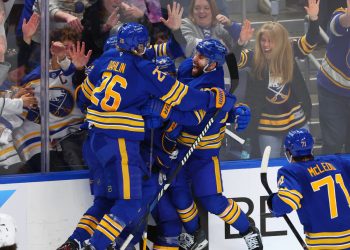 Buffalo Sabres players celebrate a goal by defenseman Mattias Samuelsson (23) during the third period in Game 1 of a first-round NHL hockey Stanley Cup playoff series against the Boston Bruins, Sunday, April 19, 2026, in Buffalo, N.Y. (AP Photo/Jeffrey T. Barnes)