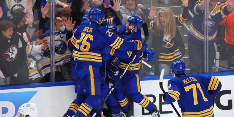 Buffalo Sabres players celebrate a goal by defenseman Mattias Samuelsson (23) during the third period in Game 1 of a first-round NHL hockey Stanley Cup playoff series against the Boston Bruins, Sunday, April 19, 2026, in Buffalo, N.Y. (AP Photo/Jeffrey T. Barnes)