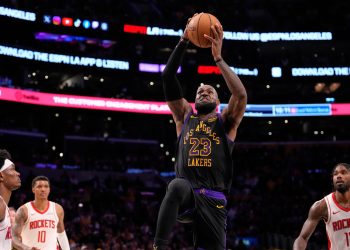 Los Angeles Lakers forward LeBron James, second from right, shoots as Houston Rockets guard Amen Thompson, left, forward Jabari Smith Jr., second from left, and forward Tari Eason defend during the second half in Game 2 of a first-round NBA playoffs basketball series Tuesday, April 21, 2026, in Los Angeles. (AP Photo/Mark J. Terrill)