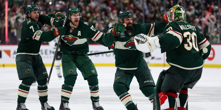 Minnesota Wild players celebrate after their team's win over the Dallas Stars during overtime of Game 4 in the first round of the NHL Stanley Cup hockey playoffs Saturday, April 25, 2026, in St. Paul, Minn. (AP Photo/Matt Krohn)