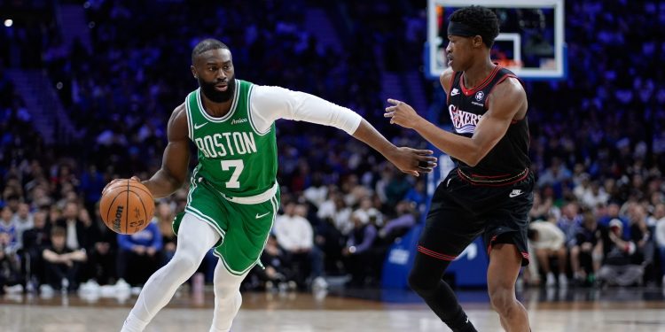 Boston Celtics' Jaylen Brown, left, tries to get past Philadelphia 76ers' VJ Edgecombe during the first half of Game 4 in a first-round NBA basketball playoffs series Sunday, April 26, 2026, in Philadelphia. (AP Photo/Matt Slocum)