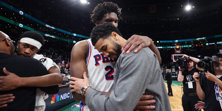 Boston Celtics' Jayson Tatum (right) and Philadelphia 76ers' Joel Embiid (left) embrace following Philadelphia's victory in Game 7 in a first-round NBA basketball playoffs series, Saturday, May 2, 2026 in Boston. (AP Photo/Jim Davis)
