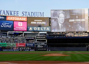 A scoreboard displays late former New York Yankees broadcaster John Sterling during a tribute to Sterling ahead of a baseball game between the New York Yankees and the Baltimore Orioles, Monday, May 4, 2026, in New York. (AP Photo/Yuki Iwamura)