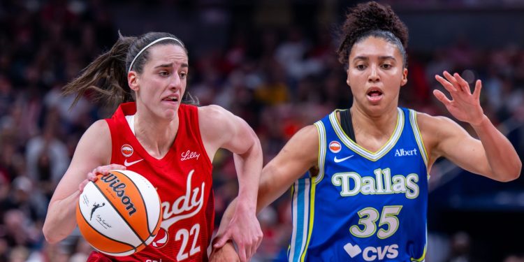 Indiana Fever guard Caitlin Clark (22) drives the ball past Dallas Wings guard Azzi Fudd (35) during the first half of an WNBA basketball in Indianapolis, Saturday, May 9, 2026. (AP Photo/Doug McSchooler)