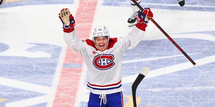 Montreal Canadiens right wing Cole Caufield (13) celebrates victory following the overtime period in Game 7 of a second-round NHL hockey Stanley Cup playoff series against the Buffalo Sabres Monday, May 18, 2026, in Buffalo, N.Y. (AP Photo/Jeffrey T. Barnes)