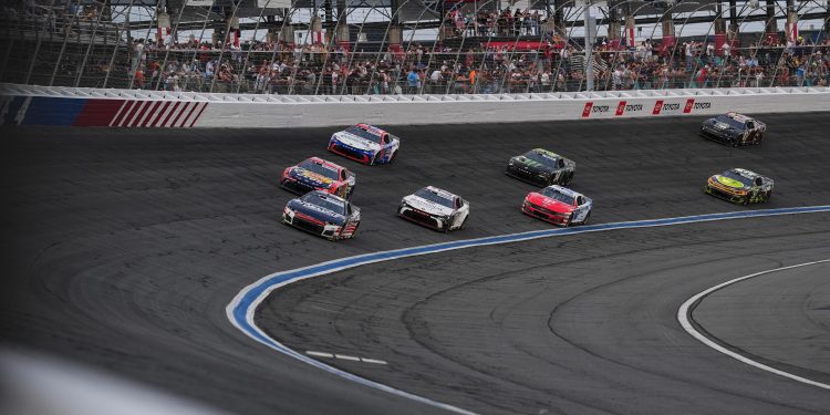 Kyle Larson (5) leads a pack of cars into Turn 4 during a NASCAR Cup Series auto race, Sunday, May 24, 2026, in Charlotte, N.C. (AP Photo/Matt Kelley)