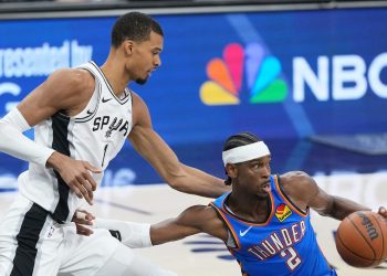Oklahoma City Thunder guard Shai Gilgeous-Alexander (2) is challenged by San Antonio Spurs forward Victor Wembanyama (1) during the first half of Game 4 in the Western Conference finals NBA basketball playoffs series in San Antonio, Sunday, May 24, 2026. (AP Photo/Eric Gay)