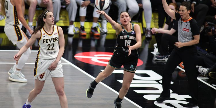 3EMEYA8 Brooklyn, USA. 06th June, 2026. Indiana Fever guard Caitlin Clark (22) looks on as New York Liberty guard Pauline Astier (18) makes a layup during the Indiana Fever V New York Liberty game at Barclays Center on Saturday, June 6, 2026; Brooklyn, New York, USA. (Photo by Jess Stiles/Sipa USA) (Photo by Jess Stiles/Sipa USA) Credit: Sipa USA/Alamy Live News