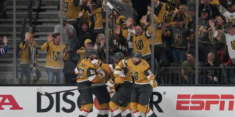 Vegas Golden Knights right wing Cole Smith (22), right, celebrates with teammates after scoring a goal during the third period in Game 4 of the Western Conference finals NHL hockey Stanley Cup playoff series against the Colorado Avalanche Tuesday, May 26, 2026, in Las Vegas. (AP Photo/John Locher)