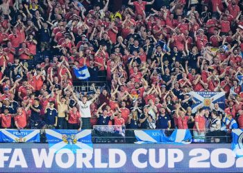 Scottish fans celebrate on the tribune over a World Cup logo during the World Cup Group C soccer match between Haiti and Scotland in Foxborough, Mass., near Boston, Saturday, June 13, 2026. (AP Photo/Martin Meissner)