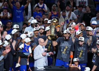 San Antonio, TX - June 13, 2026 - Frost Bank Center: Ernie Johnson with Karl-Anthony Towns (32) of the New York Knicks holding the Larry O'Brien Championship Trophy after winning game five and the 2026 NBA Finals.
(Photo by Rich Storry / ESPN Images)