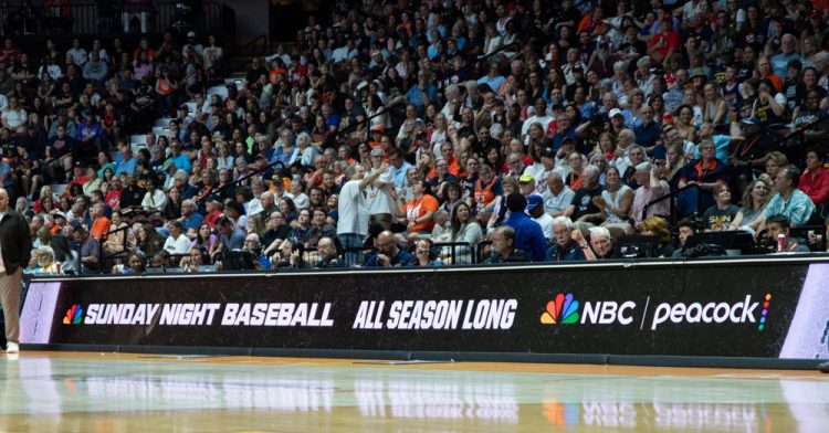 UNCASVILLE, CT - JUNE 13: An advertisement for NBC Sunday Night Baseball on NBC and Peacock is shown on the scorer’s table during the WNBA game between the Indiana Fever and the Connecticut Sun on June 13, 2026 at Mohegan Sun Arena in Uncasville, CT. (Photo by Erica Denhoff/Icon Sportswire)