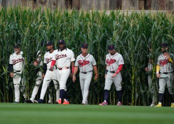 Players walk onto the field before a baseball game between the Minnesota Twins and the Philadelphia Phillies at the Field of Dreams movie site, Thursday, Aug. 13, 2026, in Dyersville, Iowa. (AP Photo/Charlie Neibergall)