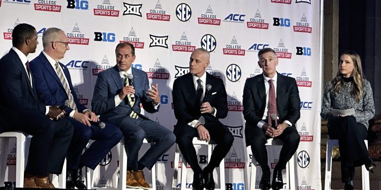The Commissioners of the NCAA's power four conferences, SEC's Greg Sankey, ACC's Jim Phillips, Big 12's Brett Yormark and Big Ten's Tony Petitti speak with ESPN's Roddy Jones, left, and Dana Boyle, right, at the College Sports Day on Capitol Hill reception in Washington, D.C., on Wednesday, April 9, 2025, after they lobbied lawmakers earlier in the day for legislation to standardize name, image and likeness and other rules. (AP Photo/Stephen Whyno )