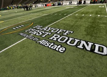 A playoff logo decorates the field before the first round of the NCAA College Football Playoff between Oregon and James Madison, Saturday, Dec. 20, 2025, in Eugene, Ore. (AP Photo/Lydia Ely)