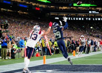 Seattle Seahawks cornerback Josh Jobe (29) intercepts the ball in front of New England Patriots wide receiver Mack Hollins (13) during an NFL football game in Seattle, Wednesday, Sept. 9, 2026. (AP Photo/Ben VanHouten)
